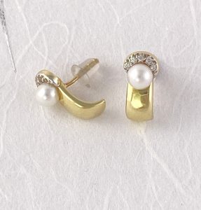 pearl studs with a diamond chip halo earrings view 1