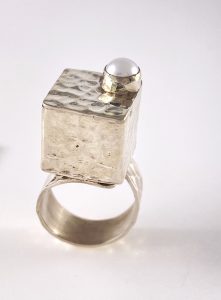 Ring that has a silver square box and pearl on the top view 2